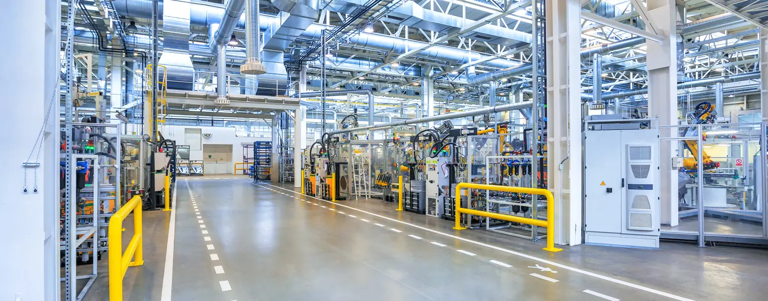 Industrial production facility with integrated equipment and building systems